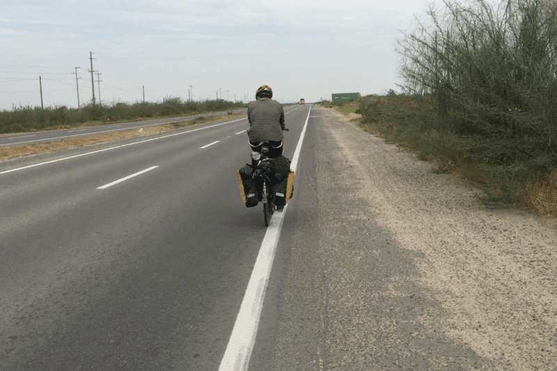 riding with another bicycle tourist - bicycle touring through the Peruvian Desert <p data-wpview-marker=